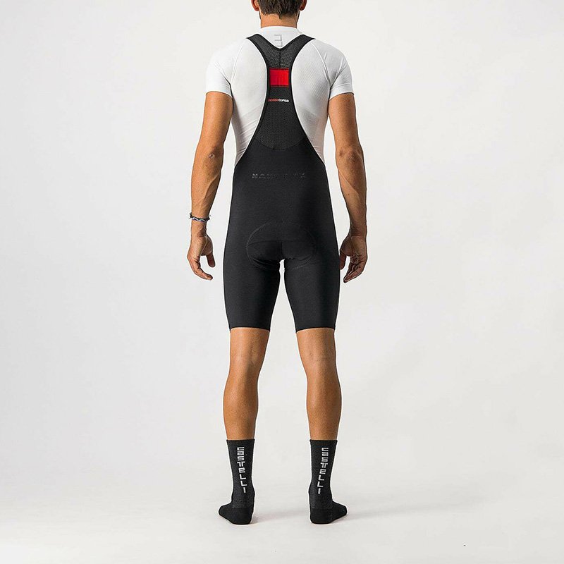 Sleek black Castelli Nano Flex Pro Race Bibshorts with knee-length cut, showcasing water-repellent fabric and mesh bibs for optimal comfort.