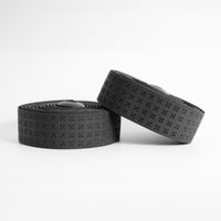 Sleek black BURGH Bar Tape Domestique Stealth with a soft, micro-raised texture for a secure grip, neatly rolled and ready.