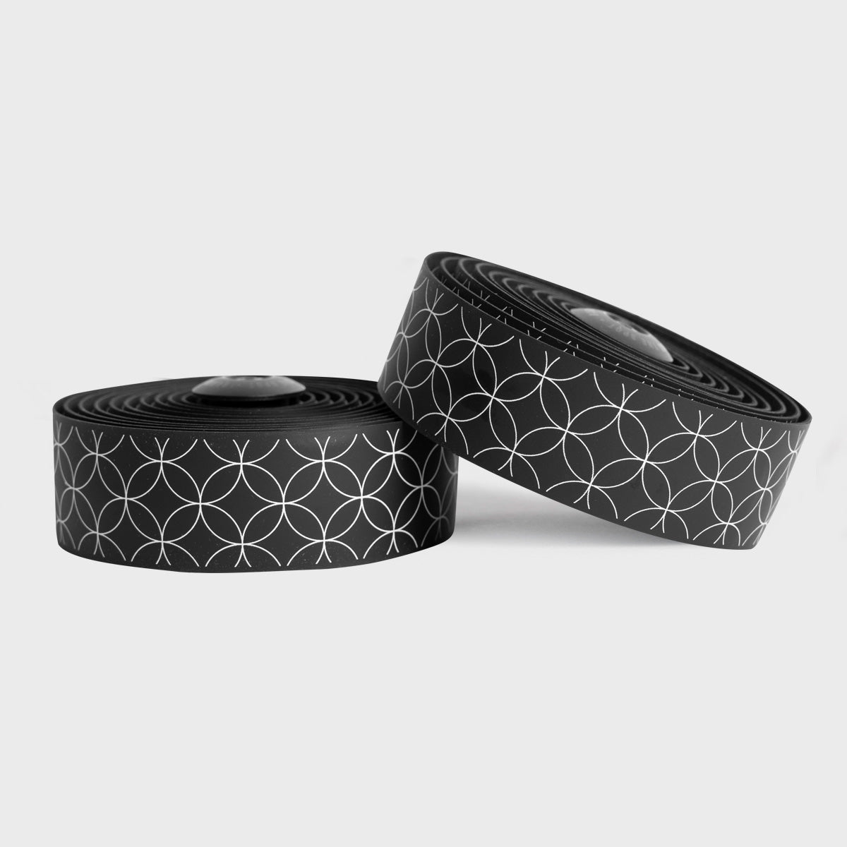 White BURGH Bar Tape Nexus with a striking black base and intricate pattern, symbolizing the unity of rider and bike.