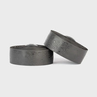 Sleek black Burgh Ossa Stealth Bar Tape with a glossy topographic map pattern and signature X’s for stylish, grippy bike handle comfort.