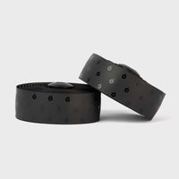Sleek black BURGH Wattbombs Stealth Bar Tape with a glossy finish, offering a grippy, stylish grip for all-weather cycling.