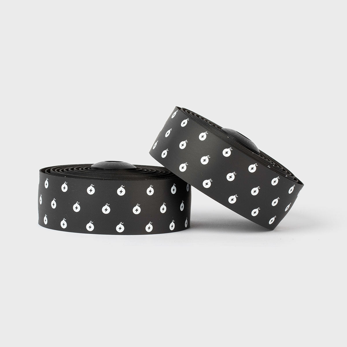 White BURGH Bar Tape Wattbombs with a sleek, glossy black print, offering a grippy, stylish grip for all-weather cycling.