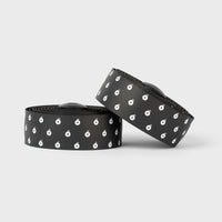 White BURGH Bar Tape Wattbombs with a sleek, glossy black print, offering a grippy, stylish grip for all-weather cycling.