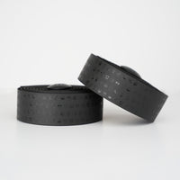 Vibrant black BURGH Bar Tape with playful emoji designs, featuring a grippy, all-weather surface for stylish cycling.