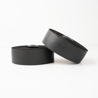 Sleek black BURGH Grunge Stealth Bar Tape with glossy print, showcasing urban style and gel-backed comfort for city rides.