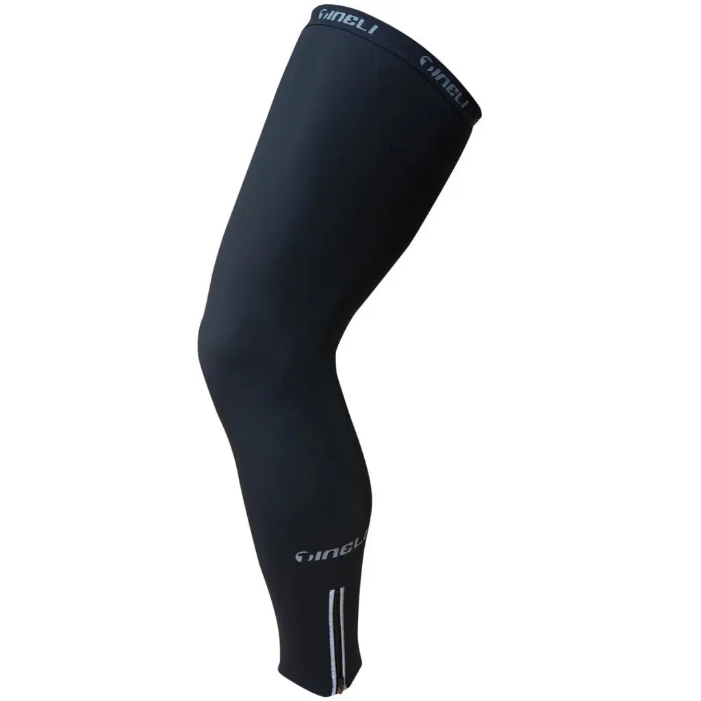 Cozy Tineli leg warmers in black or navy, crafted from soft Roubaix fabric with elastic grip bands and reflective ankle zips.